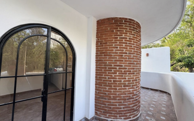 #106 Puerto Morelos - Regatta 3 BD 4 BA Condo - balcony with exposed brick and arched doorway into the home
