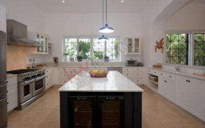 #114 Riviera Maya single family home with chef's kitchen complete with gas stove, large island for prep work, ample countertop and archway to dining room