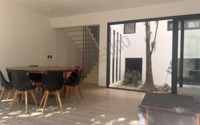 #4 Aldea Ha - 3 BD 4.5 BA Home with open concept living and dining rooms with view of the interior courtyard with trees and plants that being nature into your home